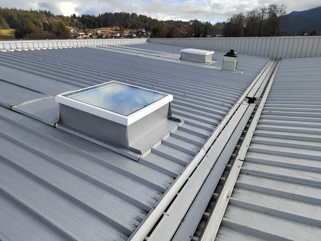 Closed STELUX glazed rooflight on an industrial metal roof